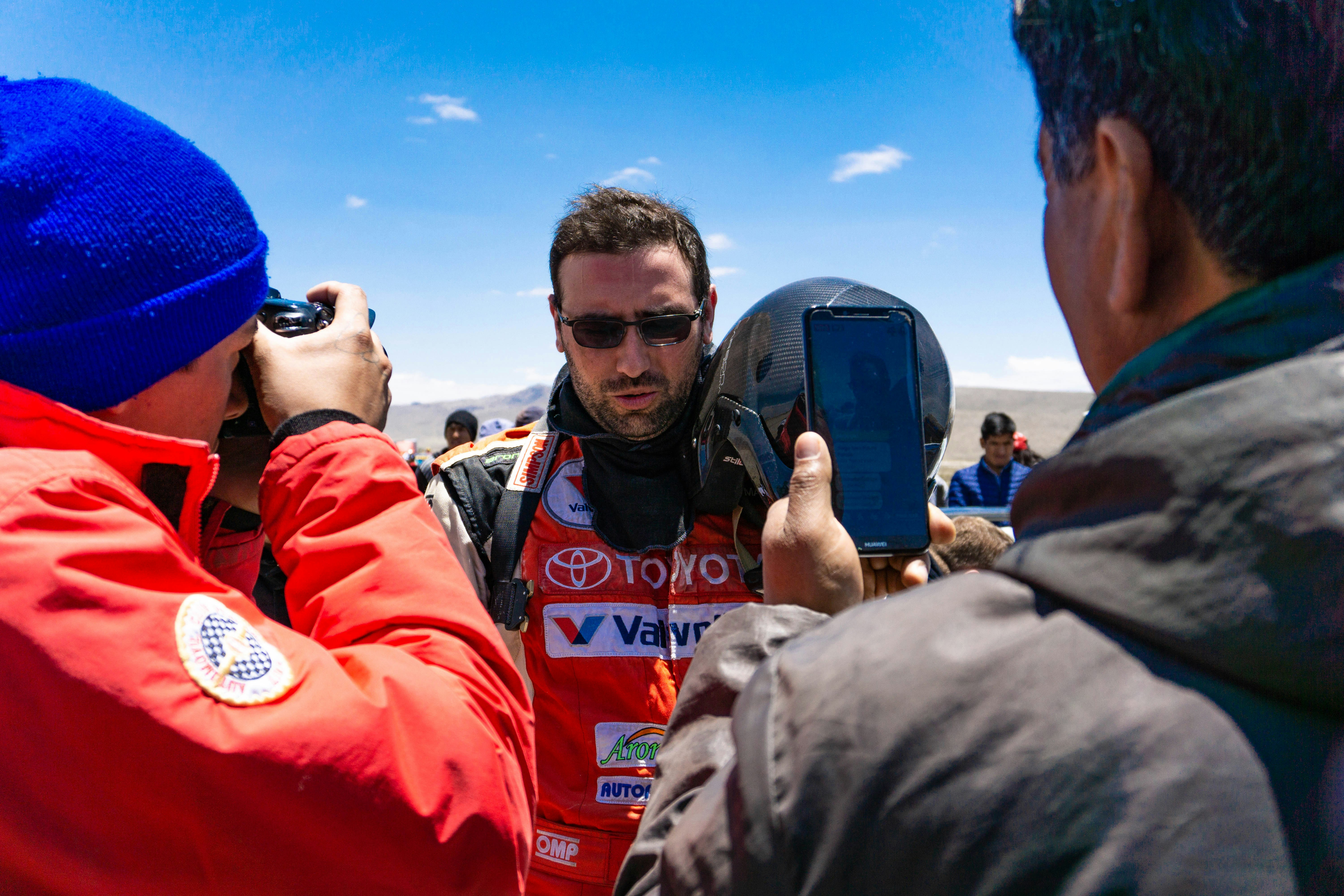 man wearing sunglasses in front of man taking photo