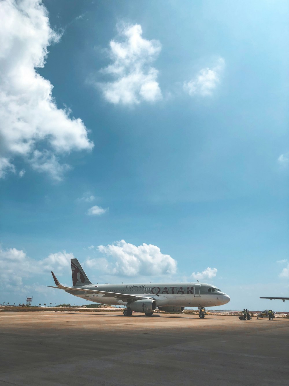 gray and white Qatar airliner during daytime