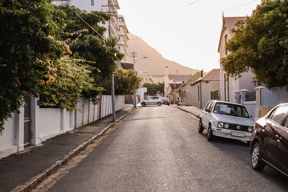 two cars parked on road near sidewalk