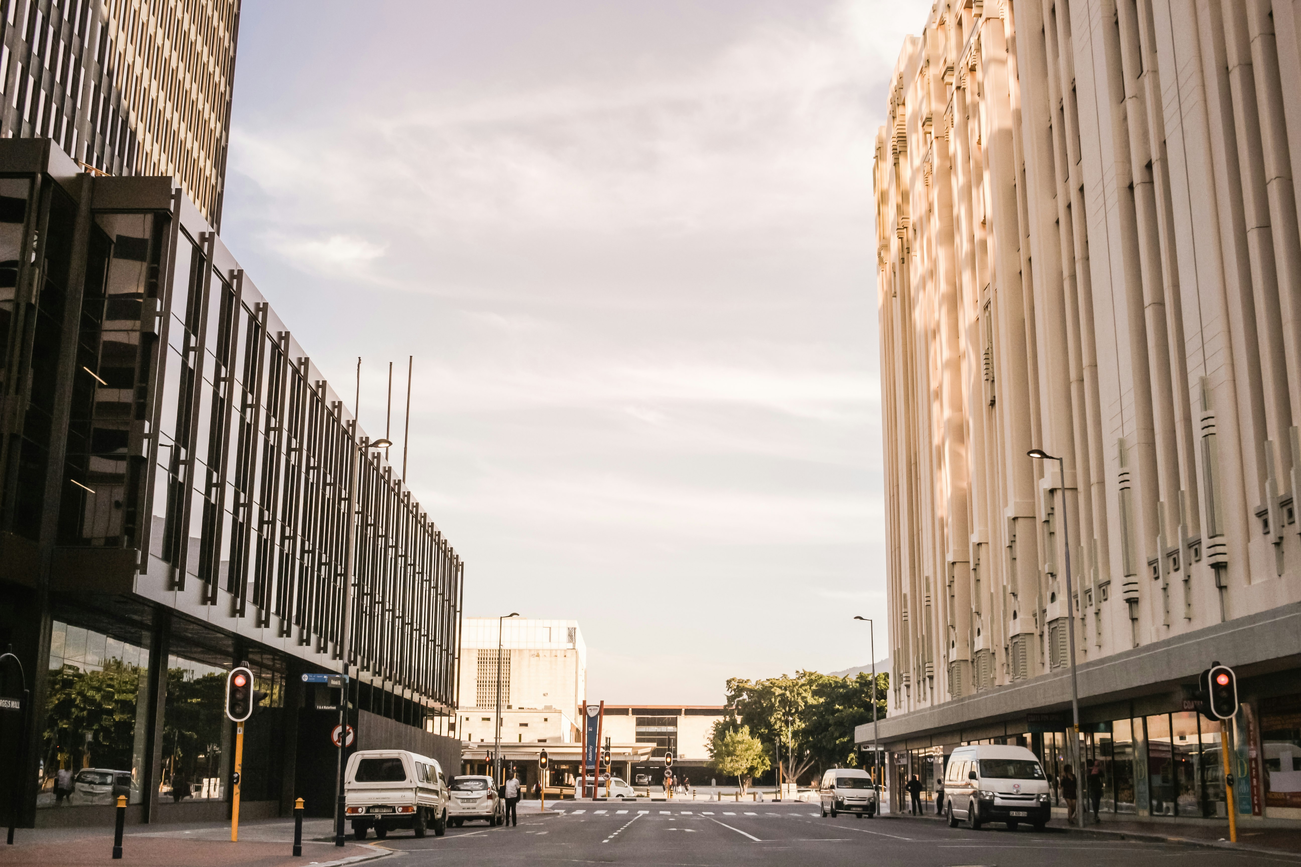 vehicles on road between buildings