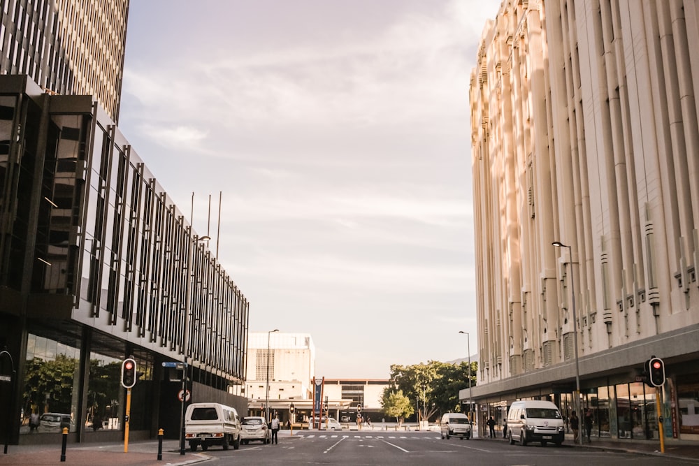 vehicles on road between buildings