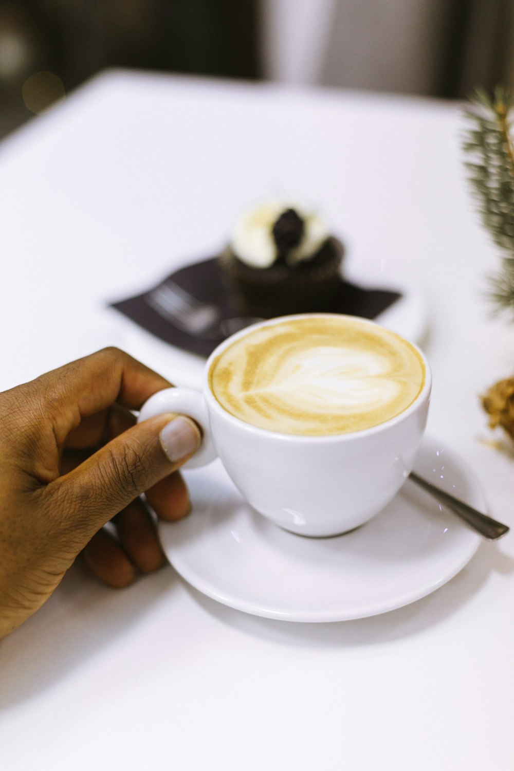 person holding fully filled mug