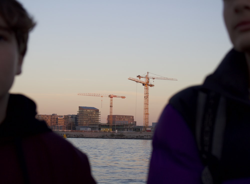 two person standing near body of water