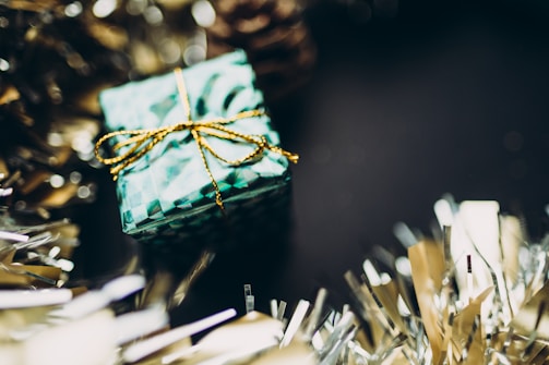 A gift box with festive decorations and wrapping.