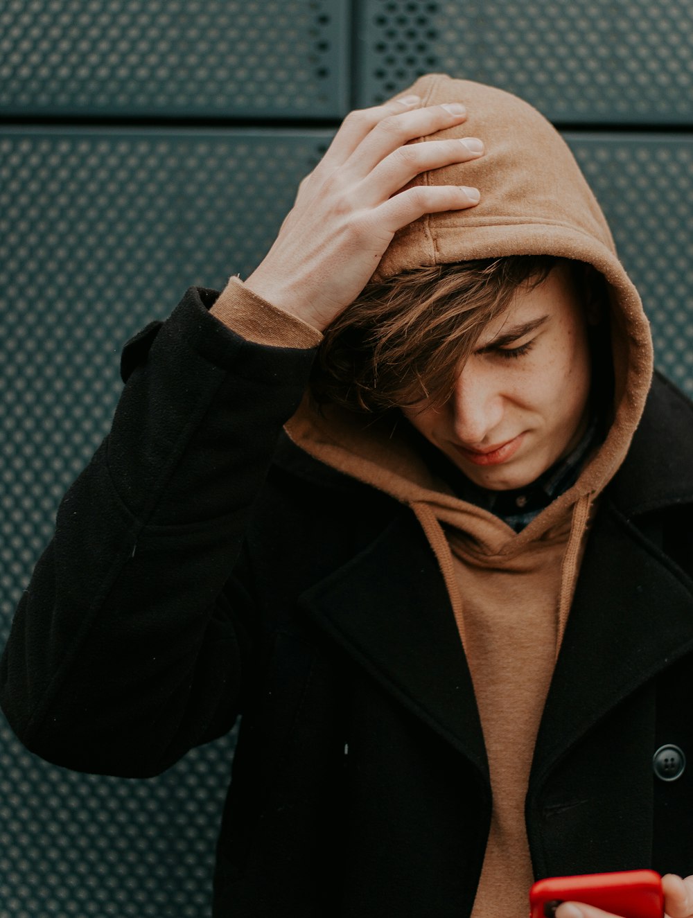 man wearing brown and black hoodie