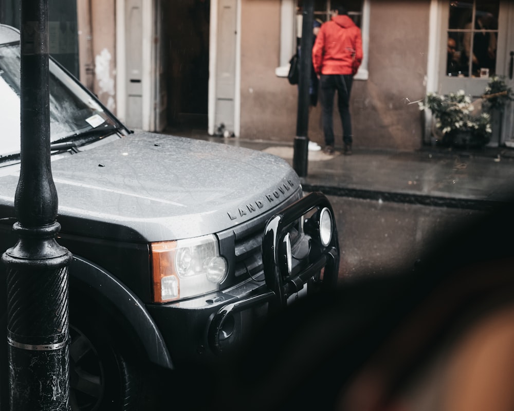 Land Rover parked near pole