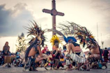 A group of locals performing a traditional dance in colorful attire during a sunny festival in Chubut.