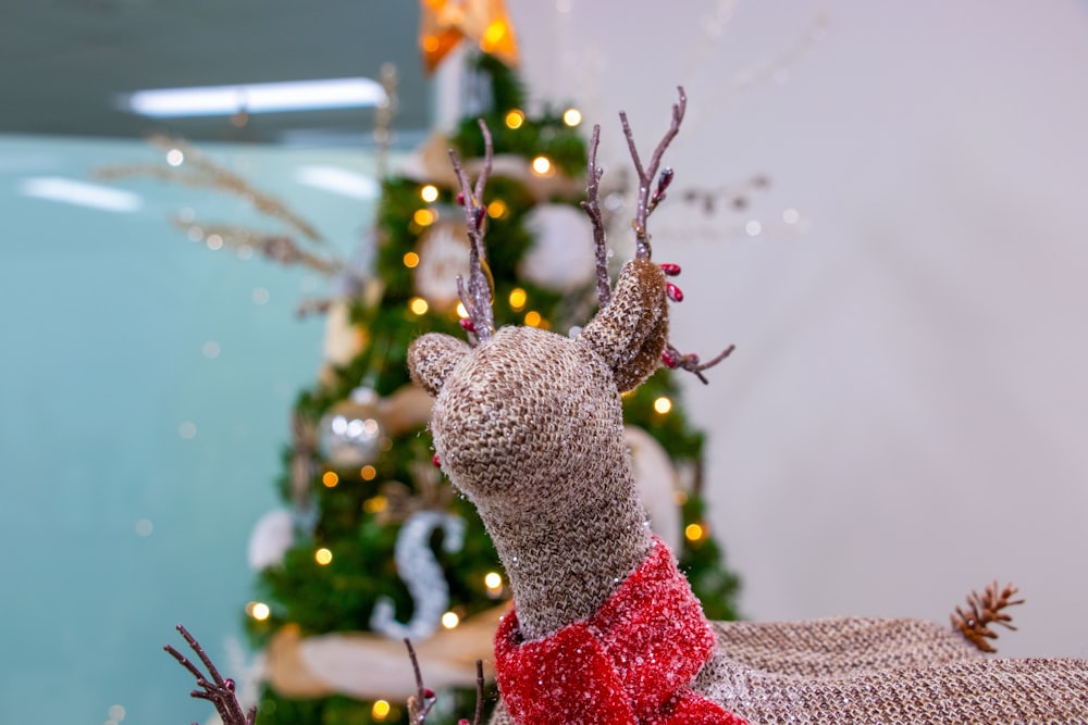 brown crochet deer near Christmas tree