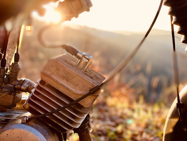 A close-up shot of a red and black motorcycle engine gleaming under sunlight.