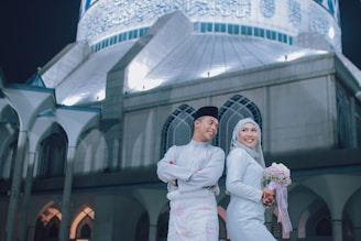 man and woman standing on front of white church