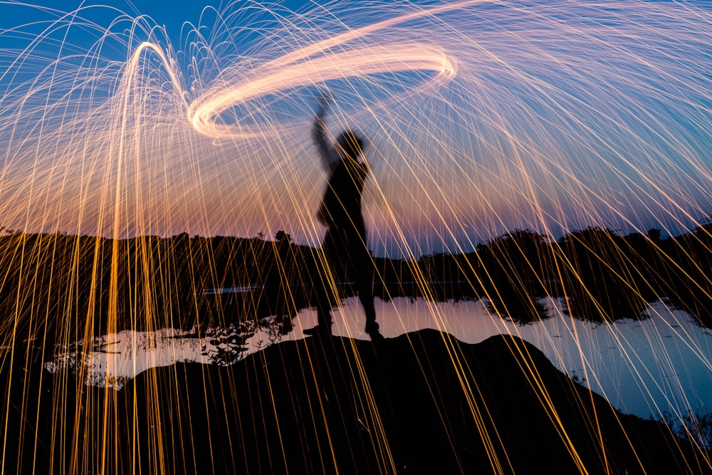 man standing on high ground in bokeh photo