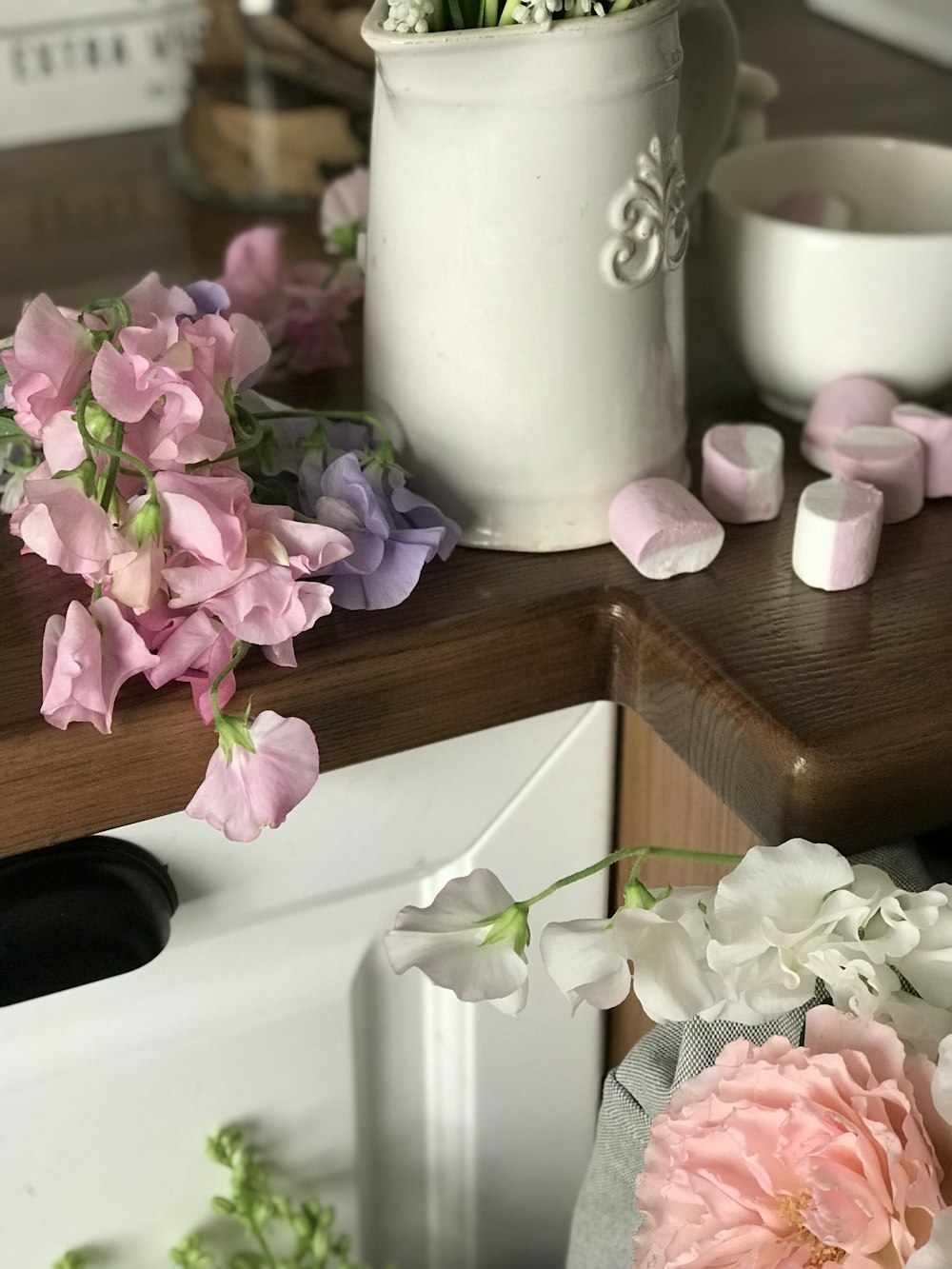 white ceramic pitcher with flowers