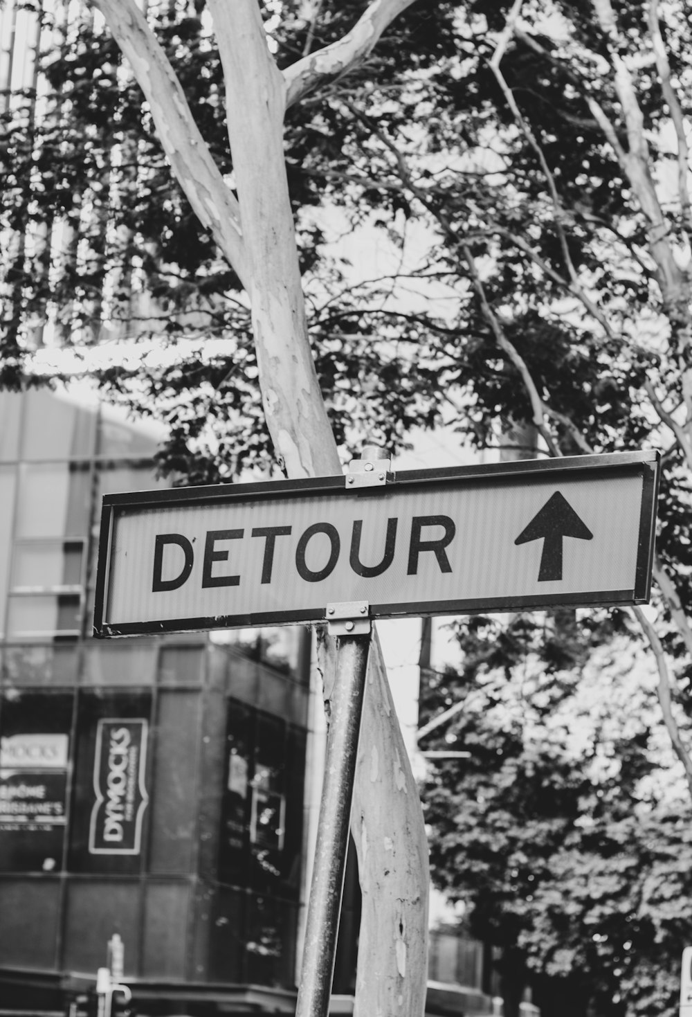 grayscale photo of detour signage