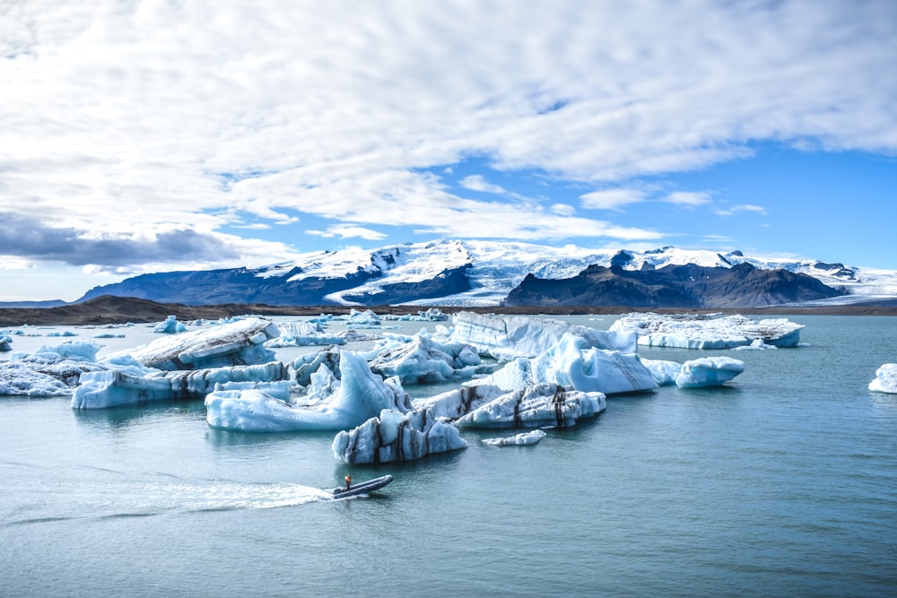 man speedboating near icebergs