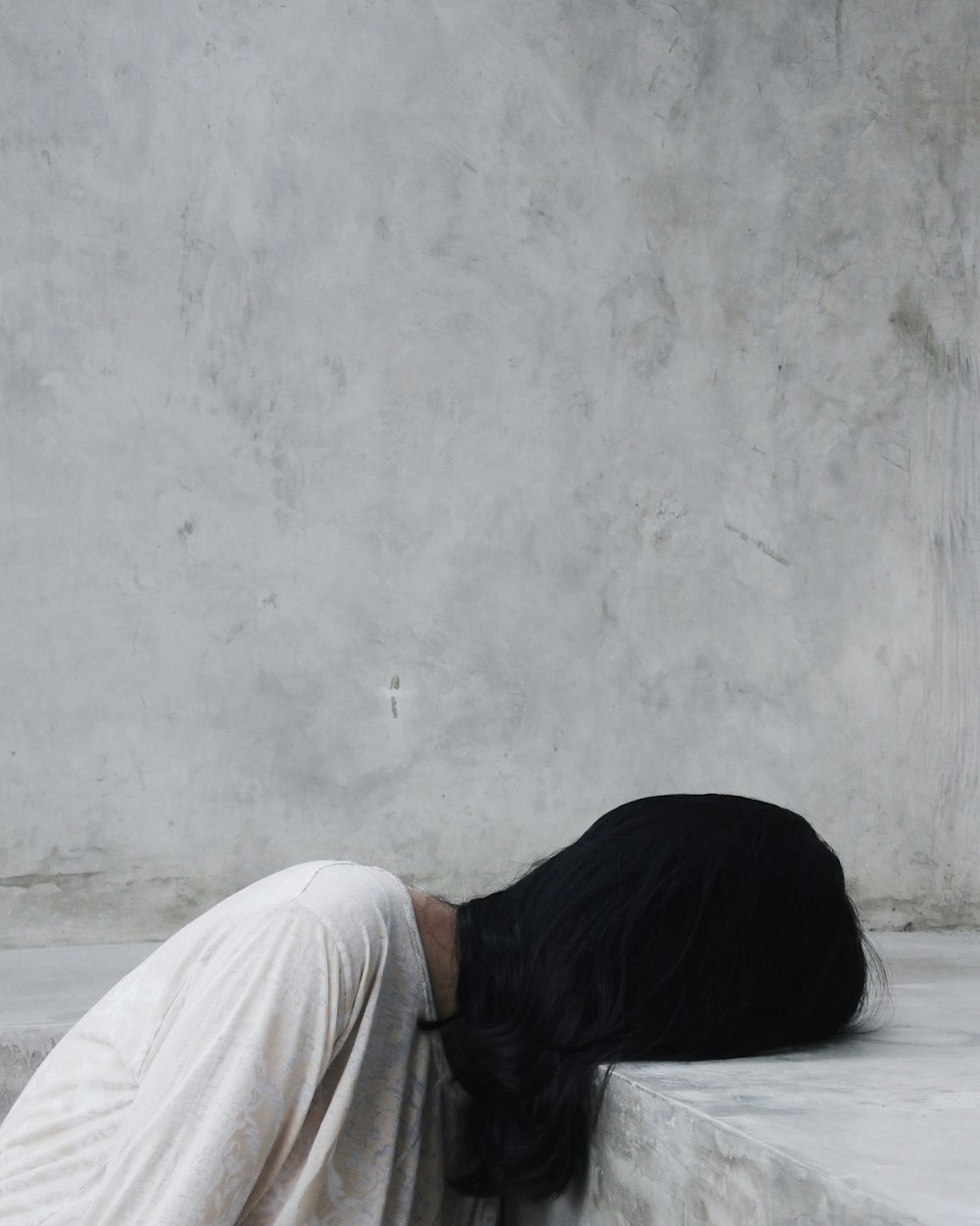 person putting head on pavement