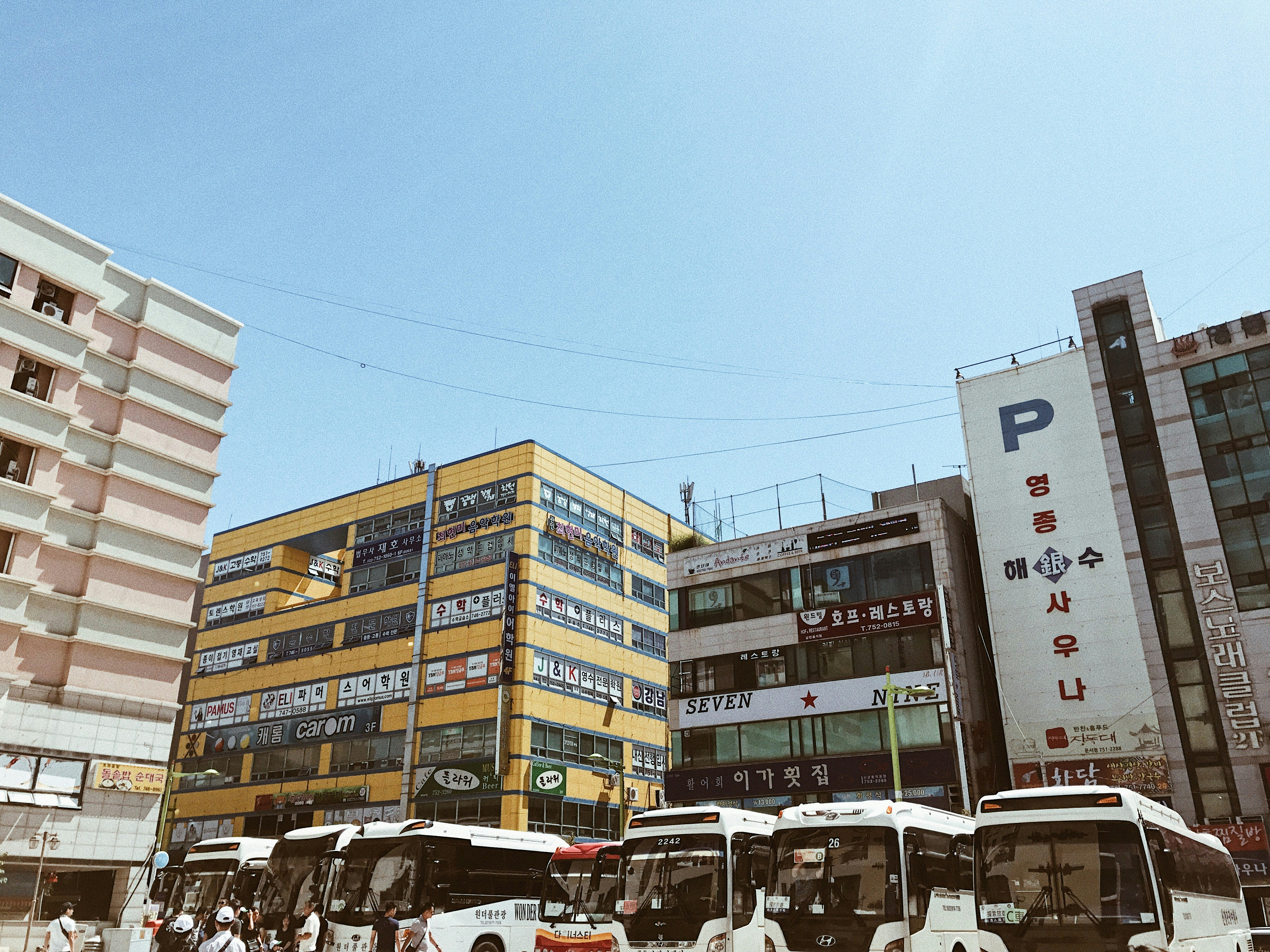 bus parked near buildings during daytime