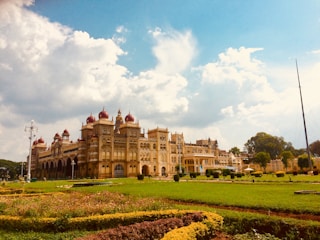 Historic Mughal-era palace with intricate arches and domes under a clear sky.