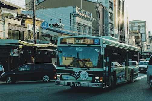 A bus driving through a scenic urban route with passengers visible