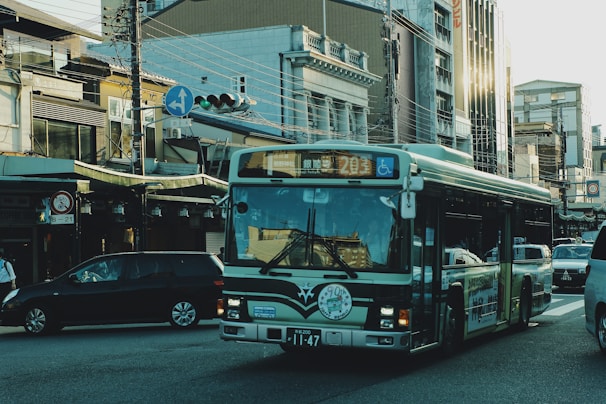 A modern city bus driving through an urban street.