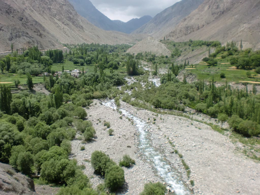A serene mountain valley with lush greenery symbolizing Kedarkhand's natural heritage.