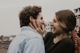 Natural, cinematic image of a couple sharing a joyful moment near the store entrance