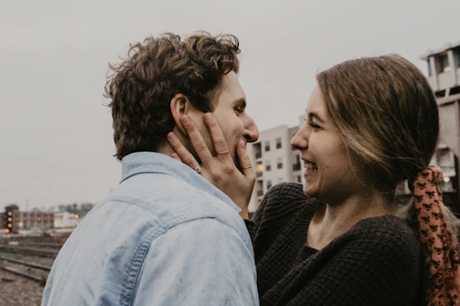 Natural, cinematic image of a couple sharing a joyful moment near the store entrance