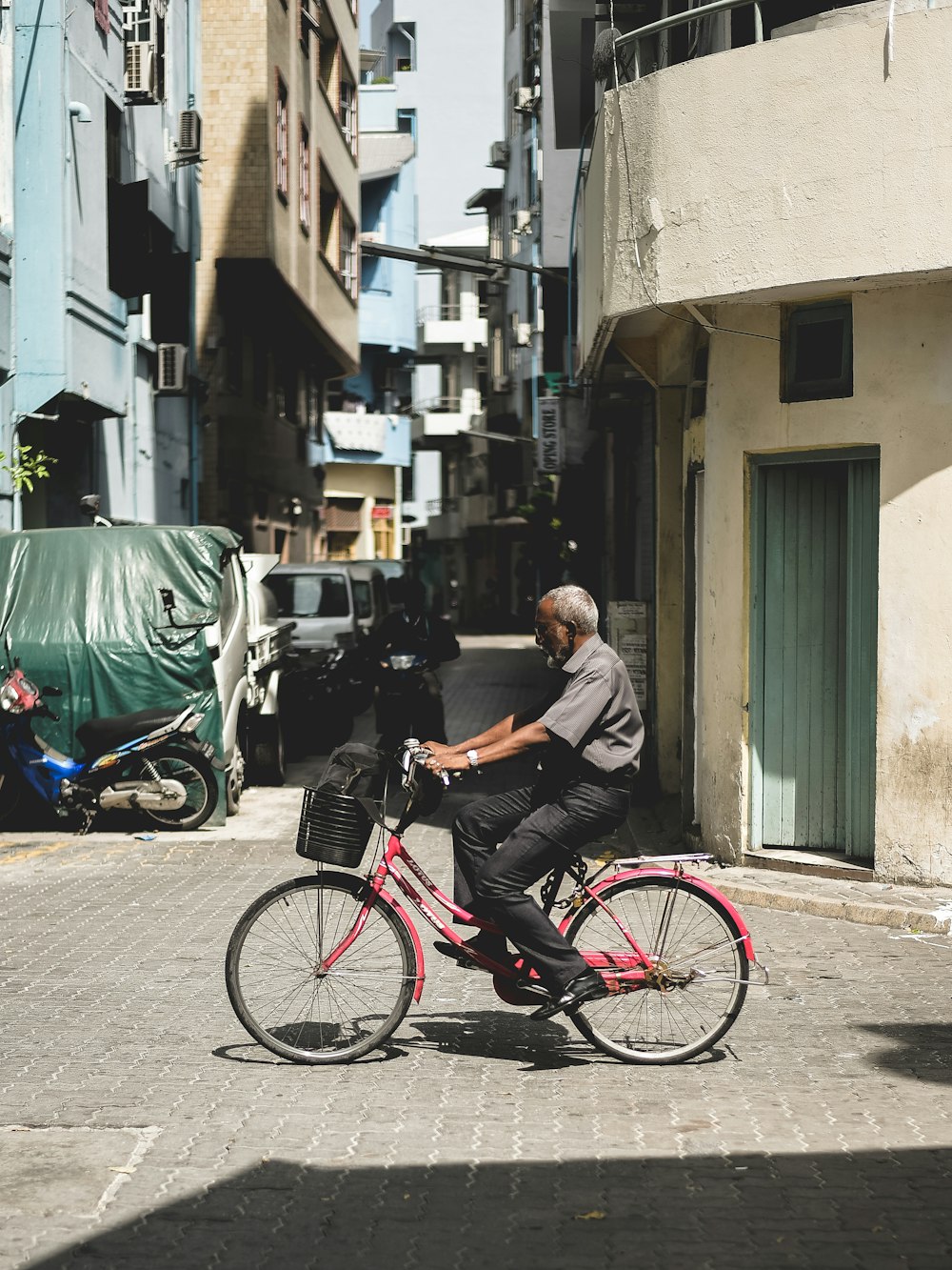 man riding bicycle on street during daytime