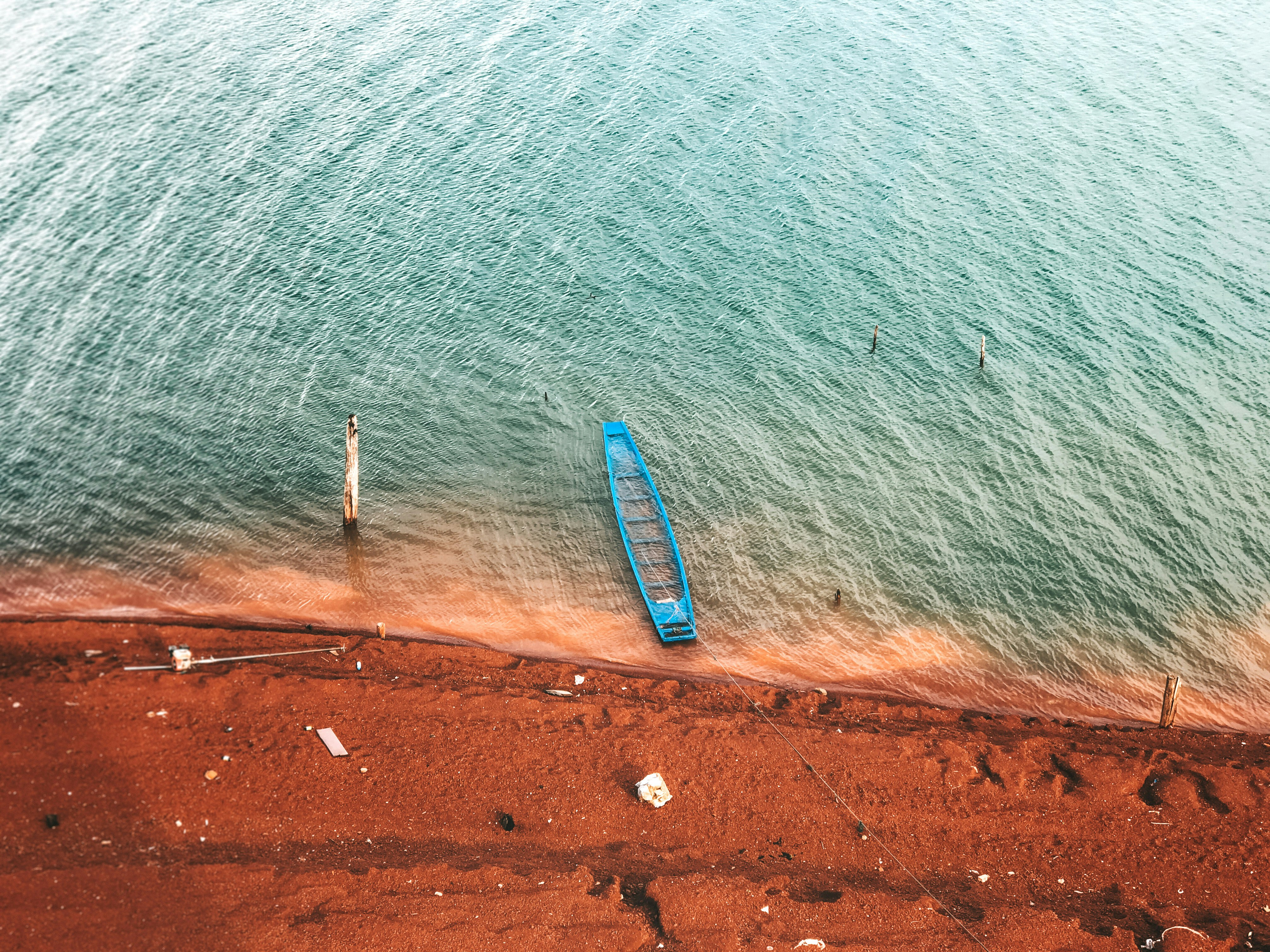 green canoe near calm sea