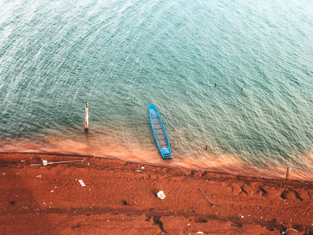 green canoe near calm sea