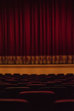 Audience engaged in an intimate underground theater setting.