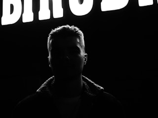 Profile image in a large hero section with headline text overlay.