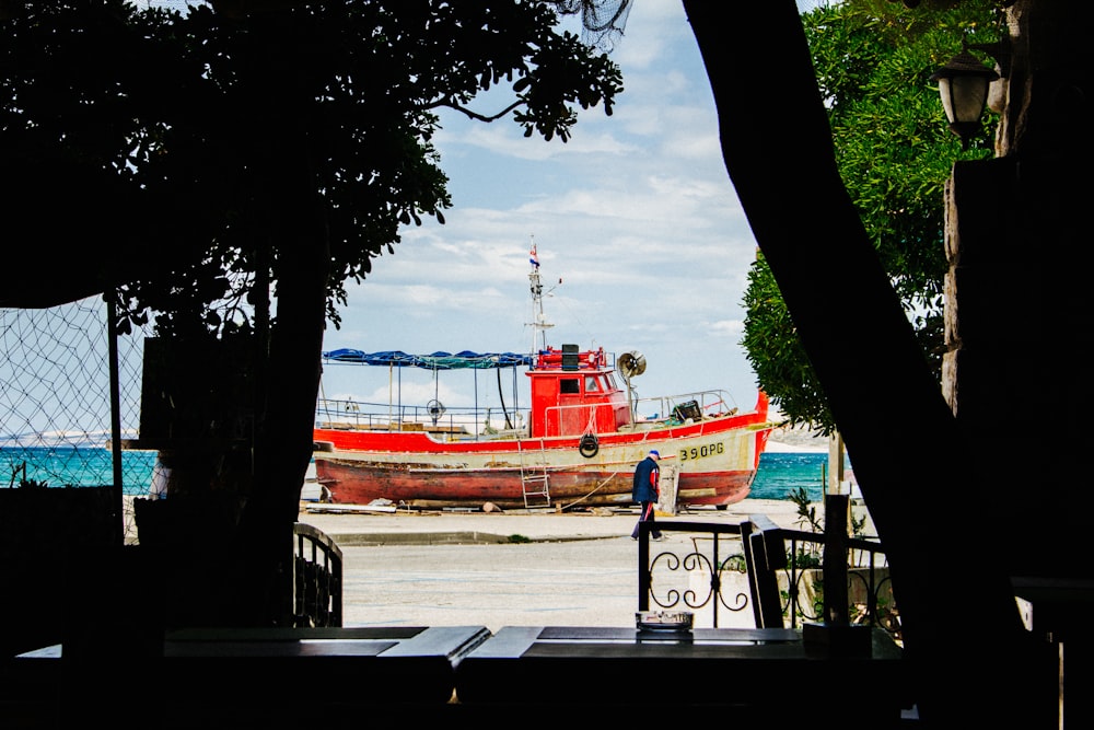 red boat under cloudy sky