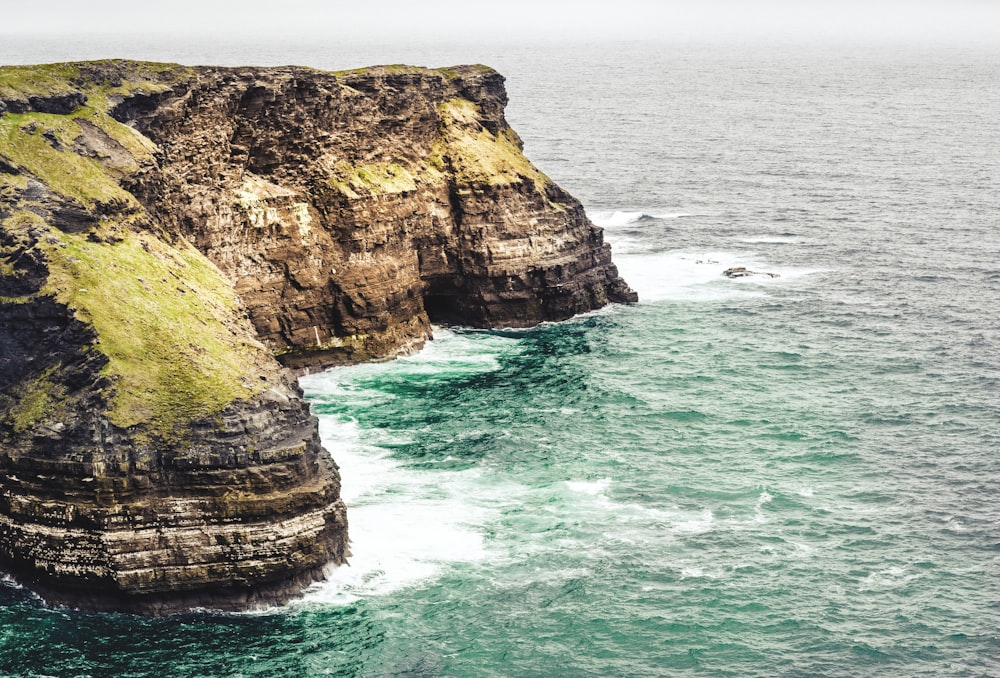 aerial photography of cliff near ocean during daytime