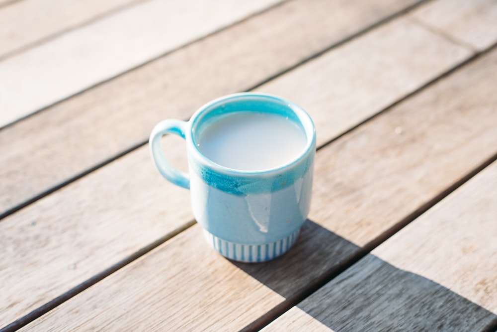 blue glass cup filled with white liquid