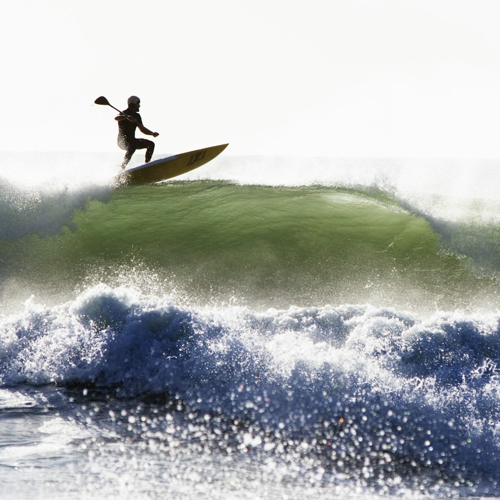 man surfing alone on sea