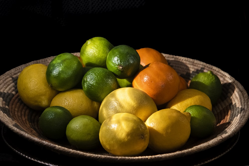 citrus fruits in brown bowl