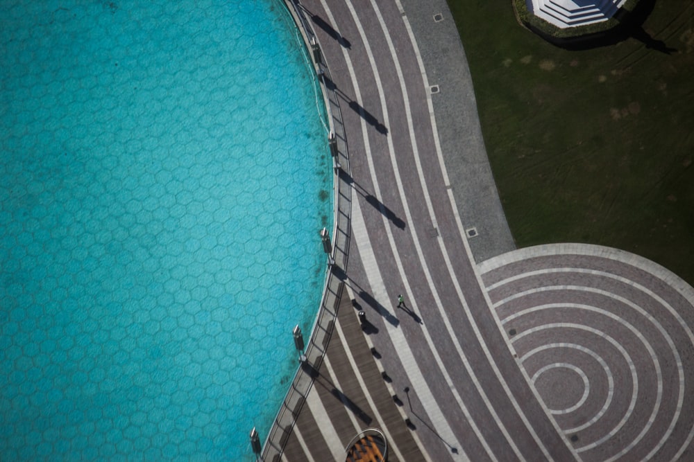 aerial photography of people walking on concrete pathway during daytime