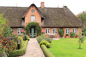 A cozy UK townhouse with a welcoming front garden on a quiet residential street.