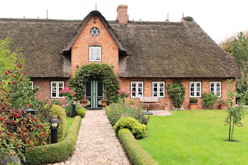 Cozy house facade with a small garden and colorful flowers.