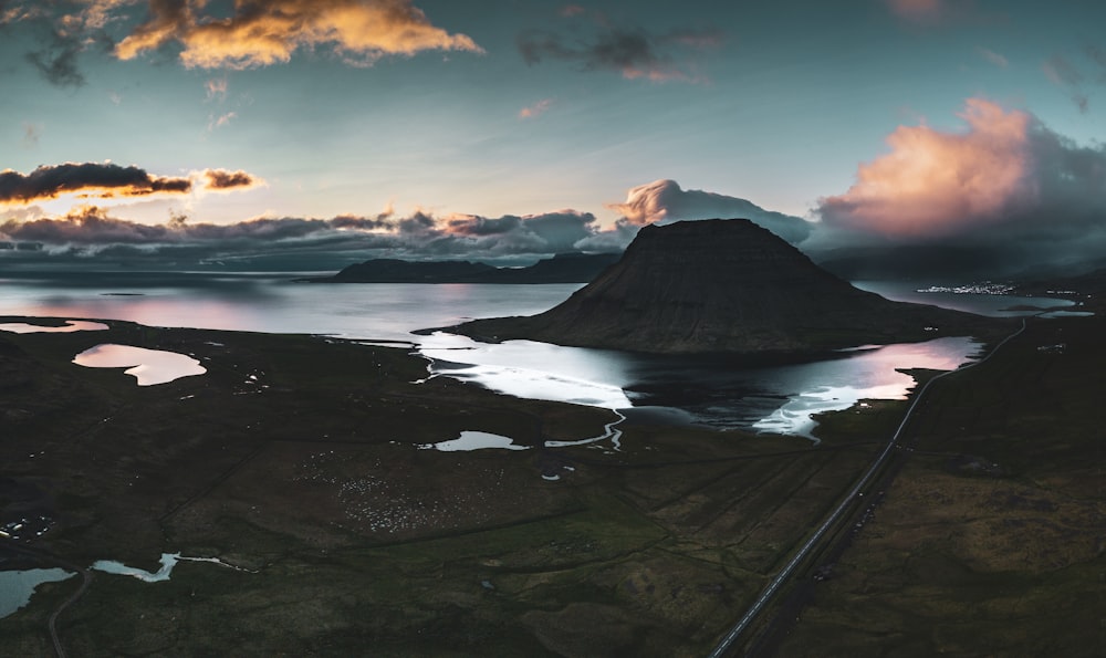 white clouds over mountain and ocean