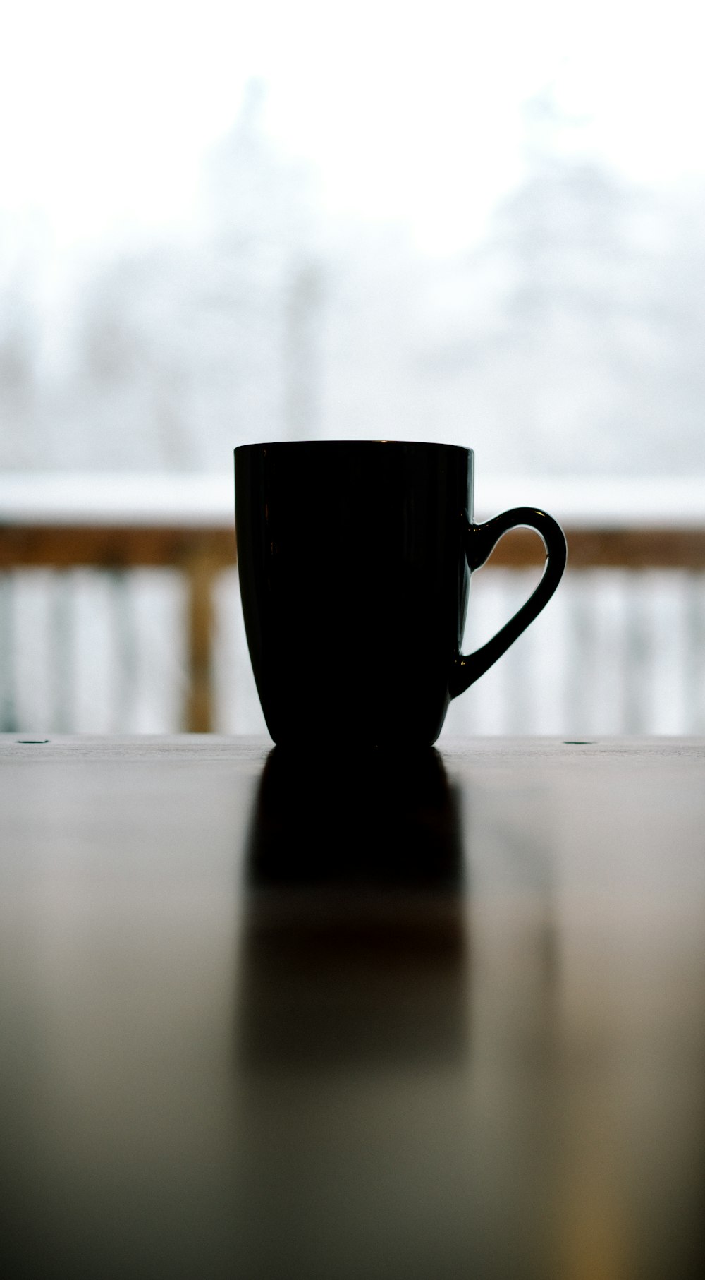 black ceramic mug on top of table