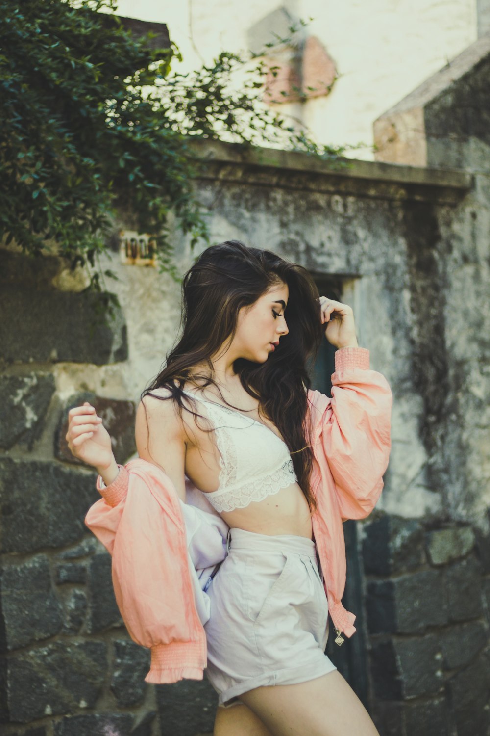 woman wearing white shorts wearing orange shirt