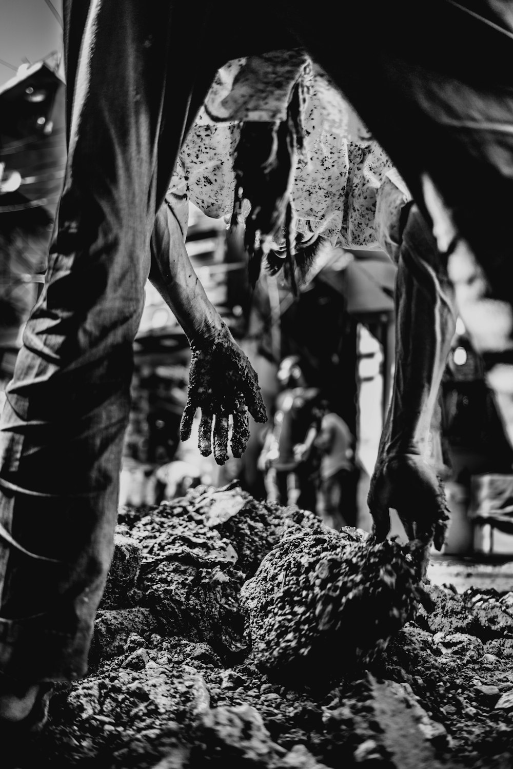 grayscale photography of person holding stone