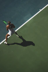 woman playing tennis on court from above