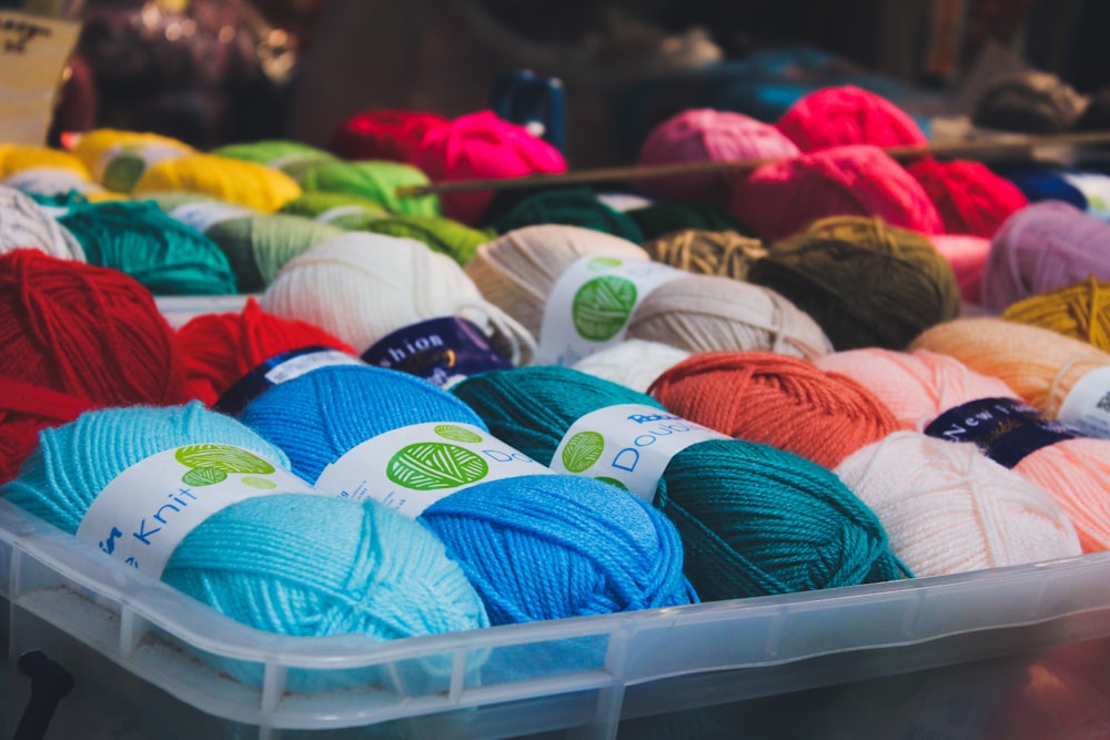 assorted-color of yarn on container