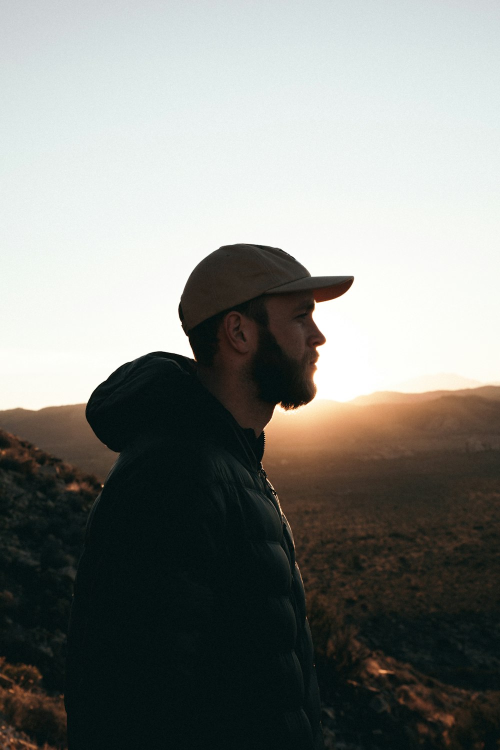 silhouette photo of man overlooking mountains