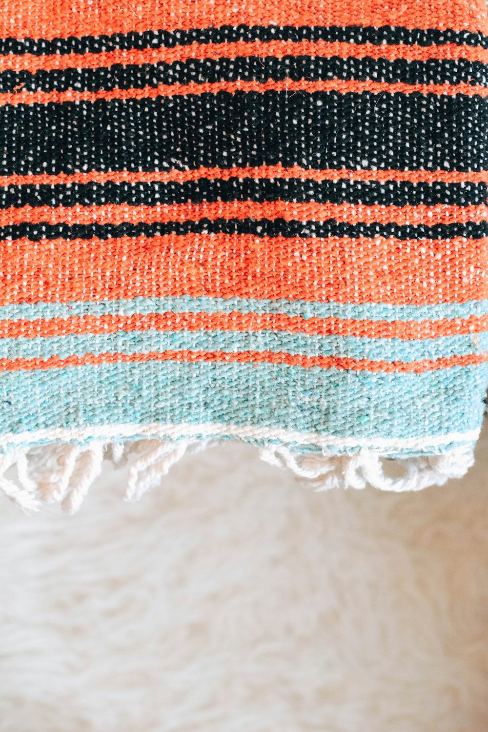 a close up of a towel on a white surface