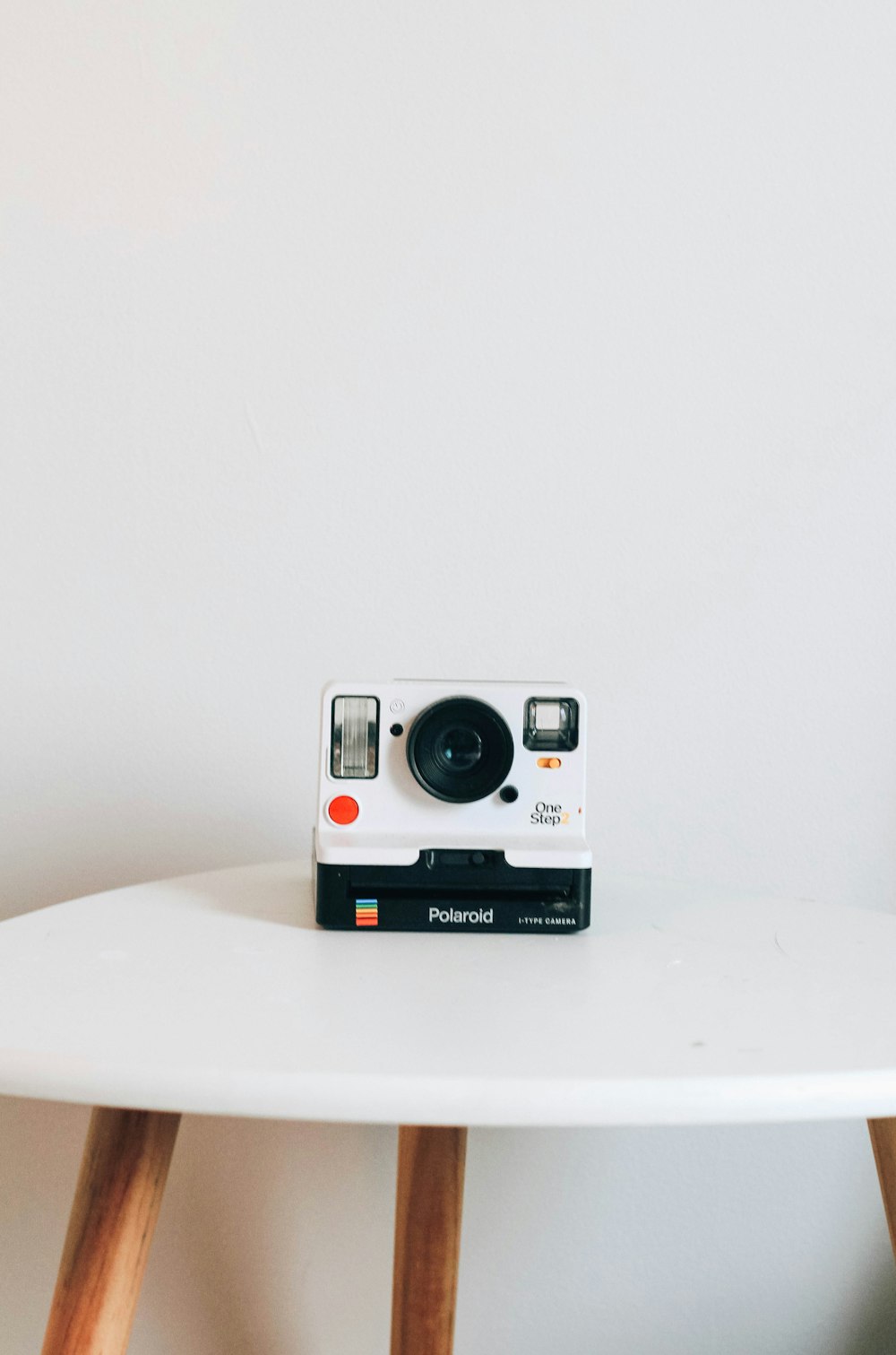 black and white Polaroid camera on top table