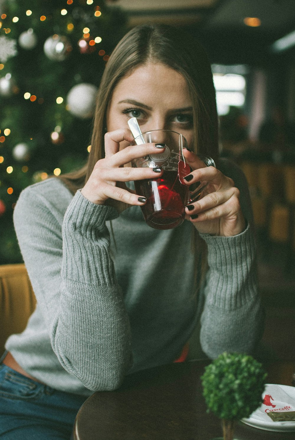 woman sitting drinking in room