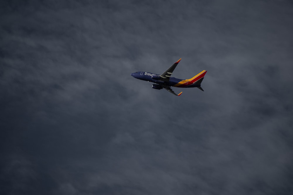 blue and orange plane on air